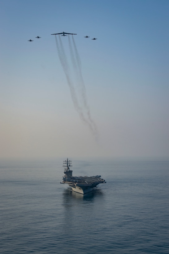The aircraft carrier USS Dwight D. Eisenhower (CVN 69) conducts a combined air wing operation with a B-52 Bomber from U.S. Air Forces Central Command in the Arabian Sea, March 18, 2020. Ike is deployed to the U.S. 5th Fleet area of operations in support of naval operations to ensure maritime stability and security in the Central Region, connecting the Mediterranean and Pacific through the Western Indian Ocean and three strategic choke points.