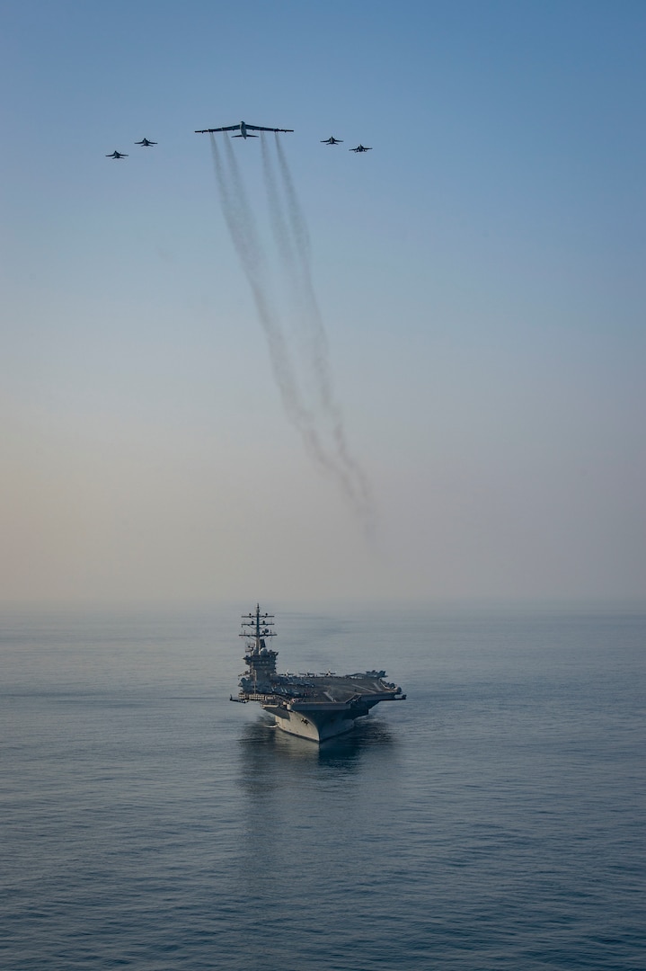 The aircraft carrier USS Dwight D. Eisenhower (CVN 69) conducts a combined air wing operation with a B-52 Bomber from U.S. Air Forces Central Command in the Arabian Sea, March 18, 2020. Ike is deployed to the U.S. 5th Fleet area of operations in support of naval operations to ensure maritime stability and security in the Central Region, connecting the Mediterranean and Pacific through the Western Indian Ocean and three strategic choke points.
