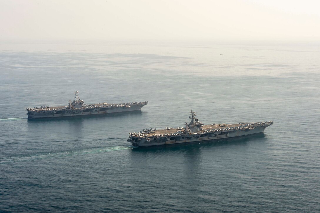 The aircraft carriers USS Dwight D. Eisenhower (CVN 69), front, and USS Harry S. Truman (CVN 75) transit the Arabian Sea March 18, 2020. The Harry S. Truman Carrier Strike Group is deployed to the U.S. 5th Fleet area of operations in support of naval operations to ensure maritime stability and security in the Central Region, connecting the Mediterranean and the Pacific through the Western Indian Ocean and three strategic choke points.