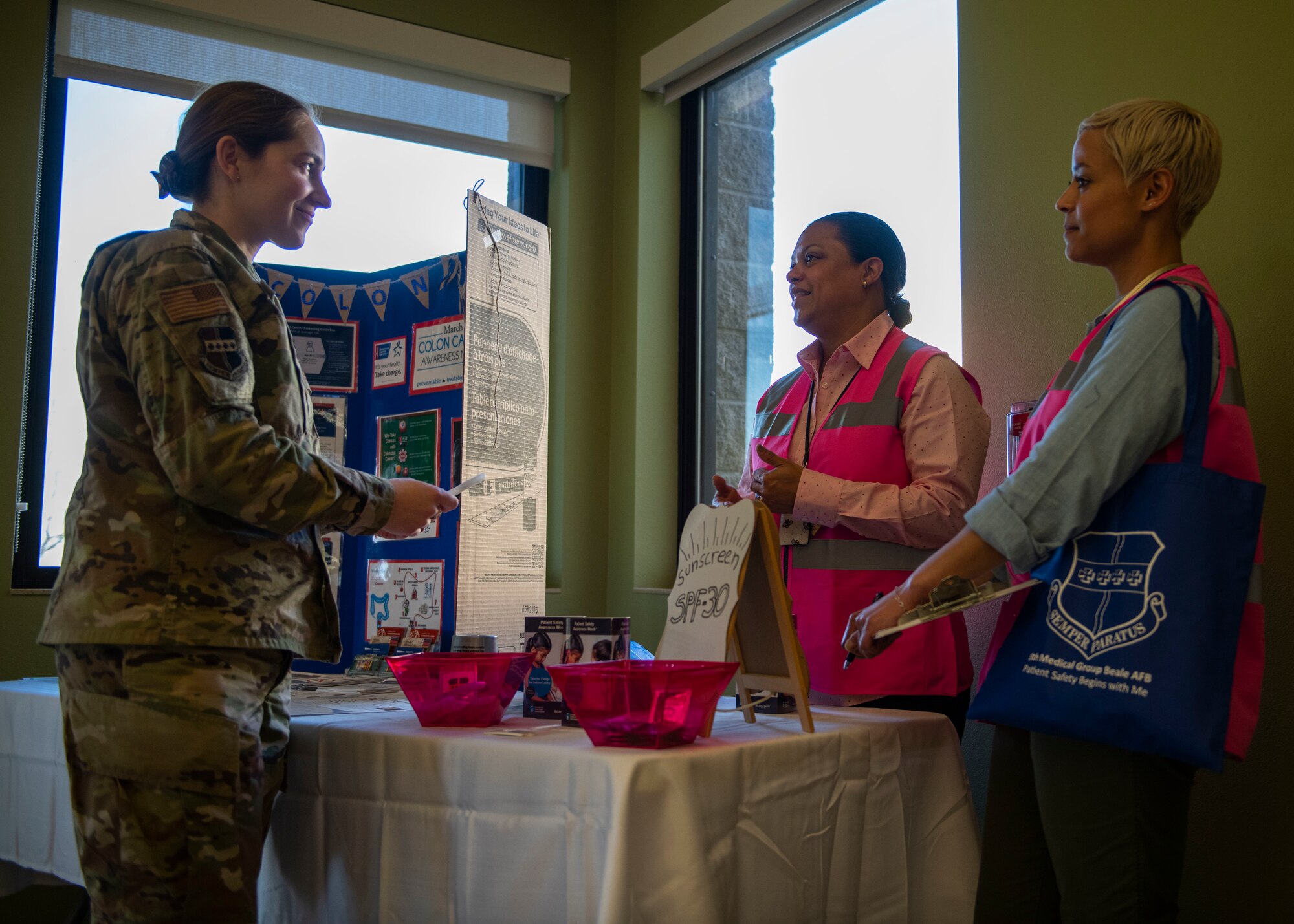 Lynn Bergmann, 9th Medical Group (MDG) Patient Safety Program Coordinator, and Denise Ross, 9th MDG Patient Advocate speak to an Airman about patient safety on Beale Air Force Base, California.