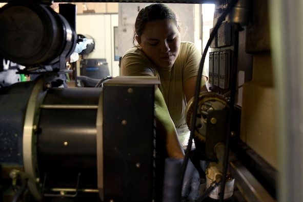 A photo of an airman replacing an oil filter