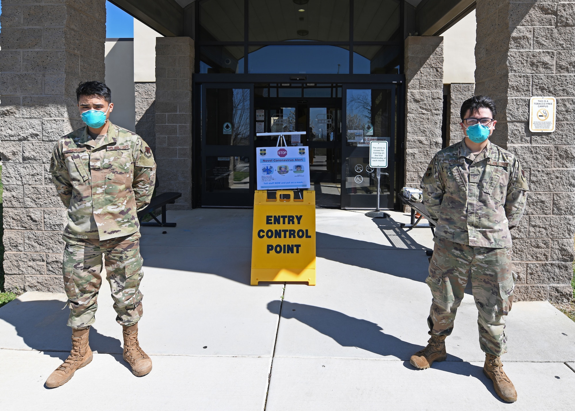 Airman Leon Guico, Left, 9th Medical Group (MDG) health administrator, and Senior Airman Christopher Miracle, 9th MDG optometry technician, guard the Entry Control Point (ECP) at the Clinic on Beale Air Force Base, California, Mar. 12, 2020. The ECP was set up at the Beale Clinic to protect Airmen and their families from the growing COVID-19 threat. (U.S. Air Force photo by Airman 1st Class Luis A. Ruiz-Vazquez)