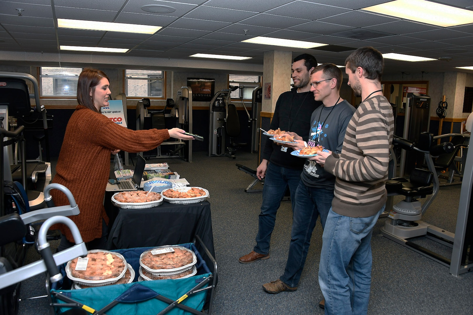 Cory William (left), Chad McKeever (middle) and Chris Ashbay (right) accept their post run apple pie from a sponsor rep after participating in the Pi Day observance March 11.