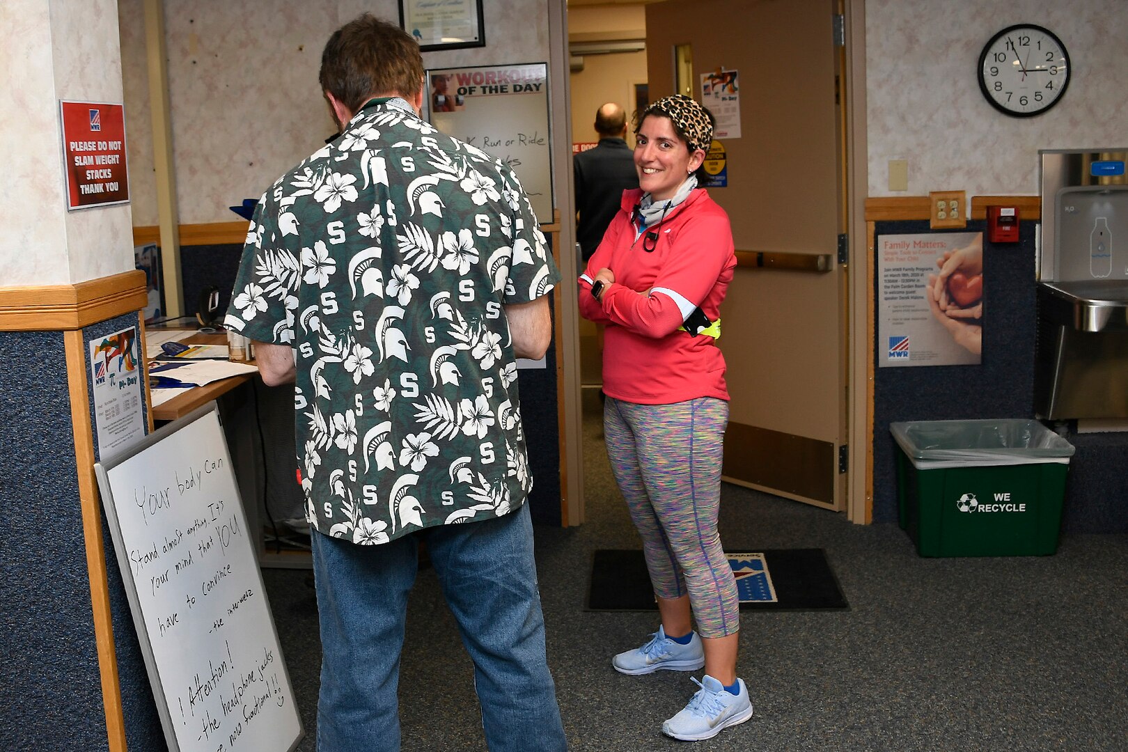 Runner (right) Jessica Waynick discusses her March 13 run for Pi Day with other Fitness Center patrons.