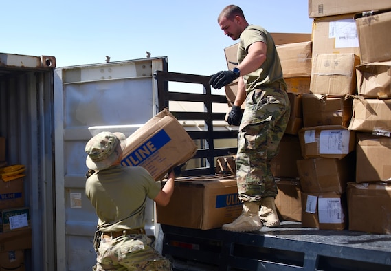 U.S. Air Force Airmen assigned to the 378th Expeditionary Contracting Squadron load a flatbed truck with contract purchases at the mailroom on Prince Sultan Air Base, Kingdom of Saudi Arabia, Mach 10, 2020. Members of the 378 ECONS are responsible for soliciting and acquiring the services and materials needed for most construction projects and services on PSAB. (U.S. Air Force by Tech. Sgt. Michael Charles)
