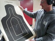 1st Sgt. James Salm inspects his target during a training session held after the unit's scheduled Battle Assembly. Local unit shooting teams and Postal Matches are a great way to improve unit training and retention.