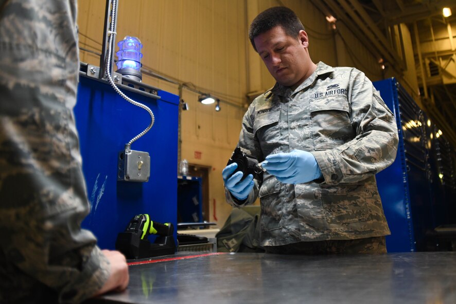 Staff Sgt. Patrick Monroe, 931st Aircraft Maintenance Squadron crew chief, checks out a reflective belt from the Consolidated Tool Kit section March 18, 2020, at McConnell Air Force Base, Kansas. Airmen working in the CTK section are now required to wear protective gloves when checking tools out to maintainers prior to their shift. (U.S. Air Force photo by Airman 1st Class Nilsa E. Garcia)