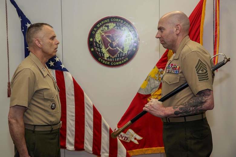 Sgt. Maj. Daniel L. Krause reports to Maj. Gen. Matthew G. Glavy, Marine Corps Forces Cyberspace Command and Joint Task Force Ares commander, during a relief and appointment ceremony in Lasswell Hall, Fort Meade, Maryland, Mar. 19, 2020. Krause relinquished his duties as the sergeant major of MARFORCYBER while Sgt. Maj. Jay D. Williamson was appointed to fill the role. (Department of Defense photo by Joseph Wilbanks)