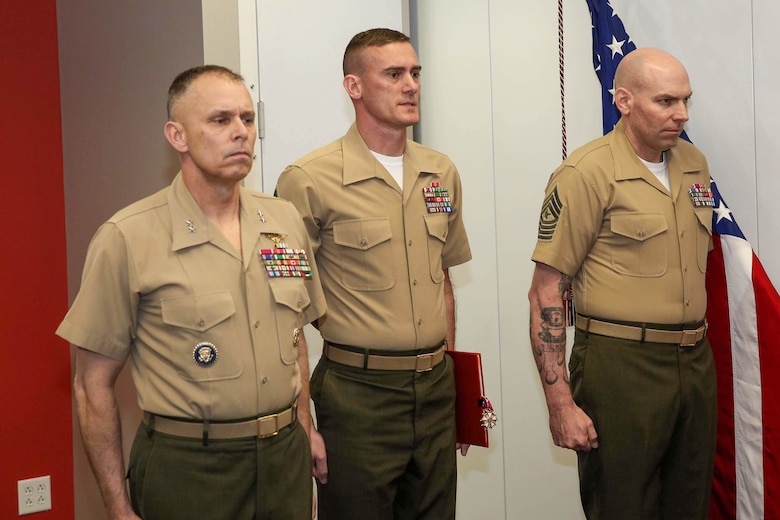 Maj. Gen. Matthew G. Glavy, Sgt. Maj. Daniel L. Krause and Sgt. Maj. Jay D. Williamson stand at attention during a relief and appointment ceremony in Lasswell Hall, Fort Meade, Maryland, Mar. 19, 2020. Krause relinquished his duties as the sergeant major of Marine Corps Forces Cyberspace Command, while Sgt. Maj. Jay D. Williamson was appointed to fill the role. (Department of Defense photo by Joseph Wilbanks)