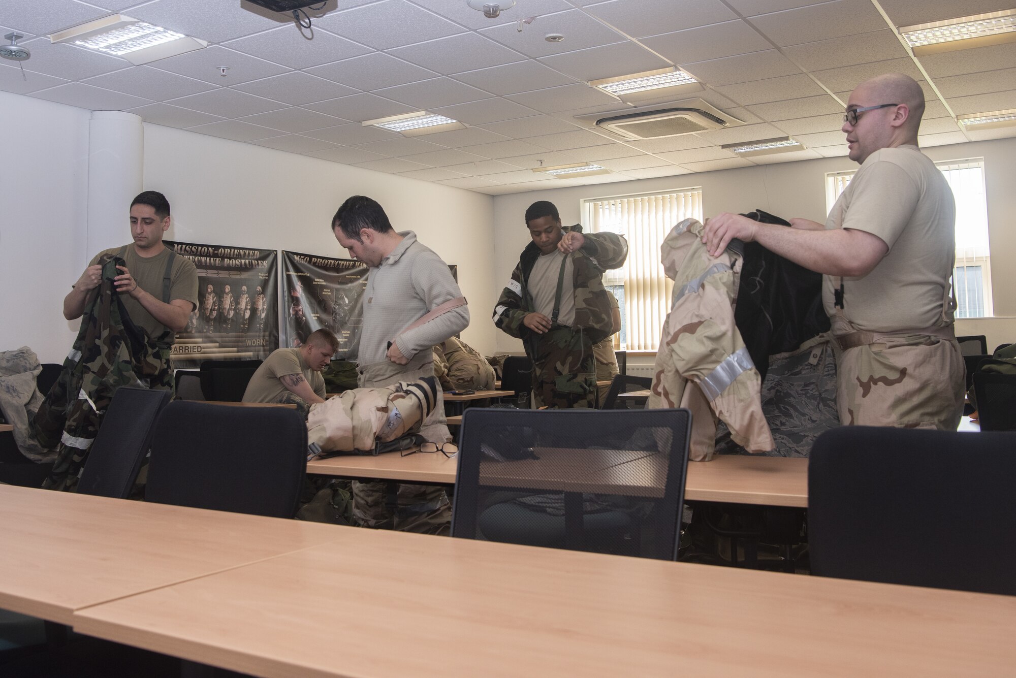 Airmen put on chemical, biological, radiological and nuclear protective gear during a CBRN defense skills class March 17, 2020, at RAF Mildenhall, England. Emergency management Airmen of the 100th Civil Engineer Squadron enhance readiness by providing CBRN training to deploying and home station members of the 100th Air Refueling Wing and 352nd Special Operations Wing. (U.S. Air Force photo by Airman 1st Class Joseph Barron)