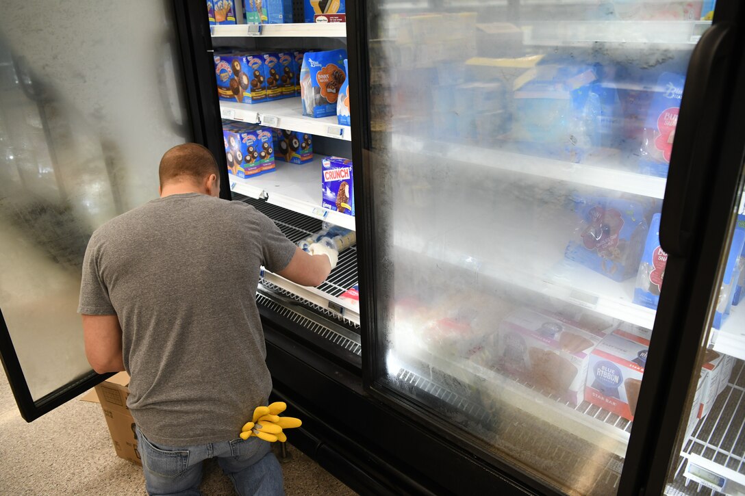 Senior Airman Cody Shumaker, 11th Contracting Squadron contract specialist, restocks ice cream at the Commissary at Joint Base Andrews, Md., Mar. 19, 2020. JBA community members volunteered their time to help restock shelves due to high demand of products during the COVID-19 outbreak. (U.S. Air Force photo by Airman 1st Class Spencer Slocum)