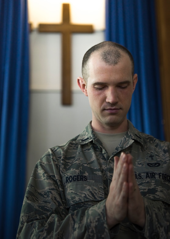 1st Lt. Jacob Rogers, 366th Fighter Wing chaplain, bows his head in prayer, March 18, 2020, at Liberty Chapel on Mountain Home Air Force Base, Idaho. The Chapel has started transitioning most of its programs and services to online platforms to continue to take care of Airmen and families during the Covid-19 pandemic. (U.S. Air Force photo by Airman 1st Class Andrew Kobialka)
