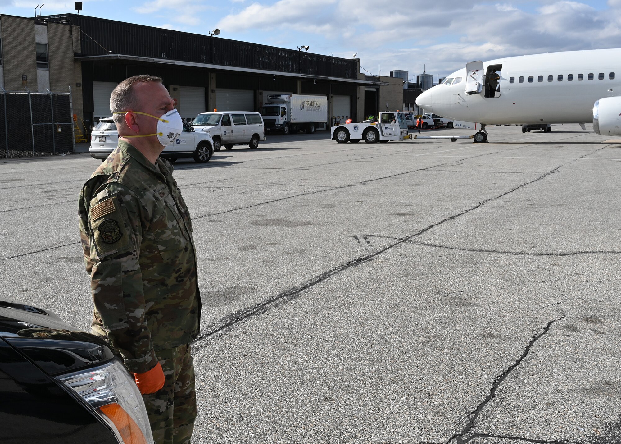 U.S. Air Force Master Sgt. William Hohman, 275th Cyberspace Operations Squadron, Maryland Air National Guard, stands ready at Baltimore Washington International Airport, March 17, 2020, before transporting passengers from the Grand Princess cruise ship who have been quarantined due to the novel Coronavirus (COVID-19) pandemic. The Maryland National Guard has activated 1,000 personnel with another 1,200 Airmen and Soldiers ready at an enhanced state of readiness