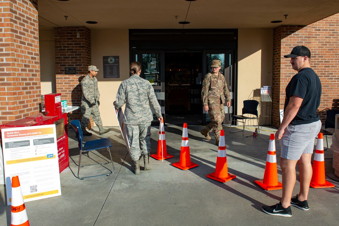 Photo of Moody Airmen setting up for a Stop, Check, Go health screening in front of the commissar.