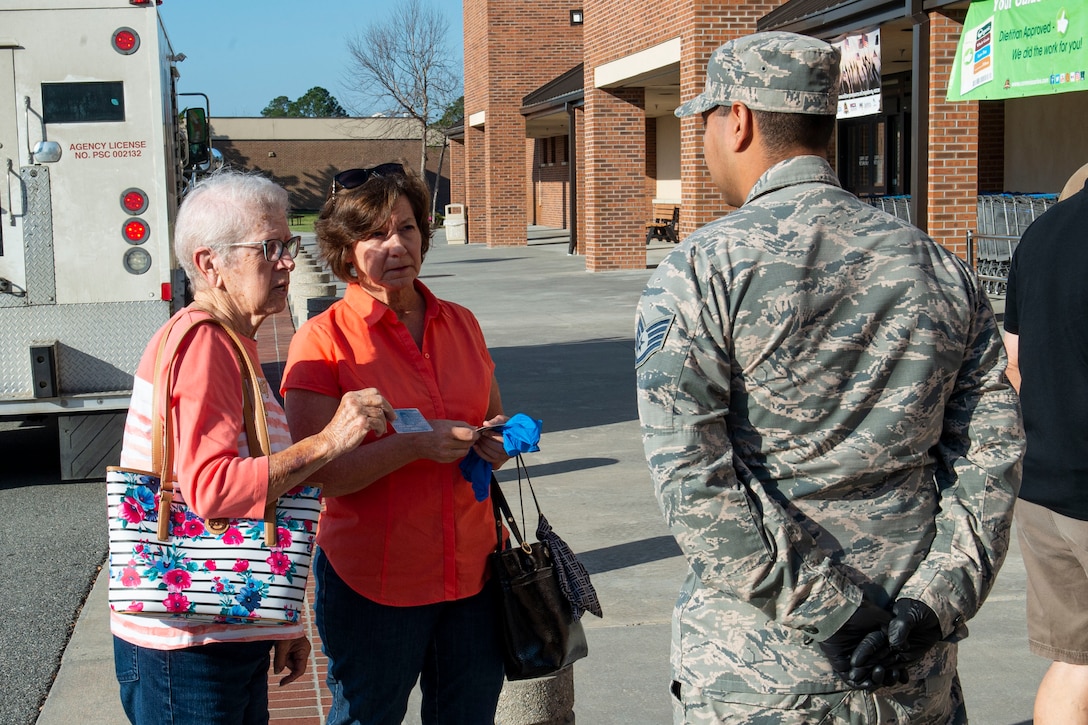 Photo of an Airman checking IDs.