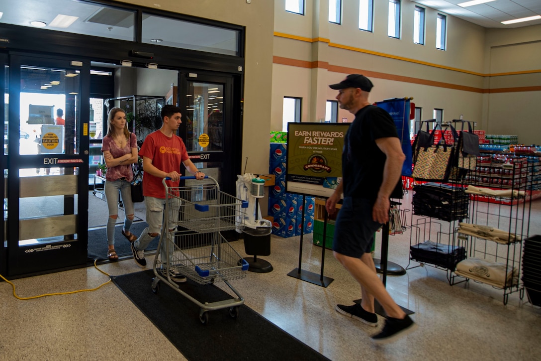 Photo of customers walking into the commissary after a health screening.