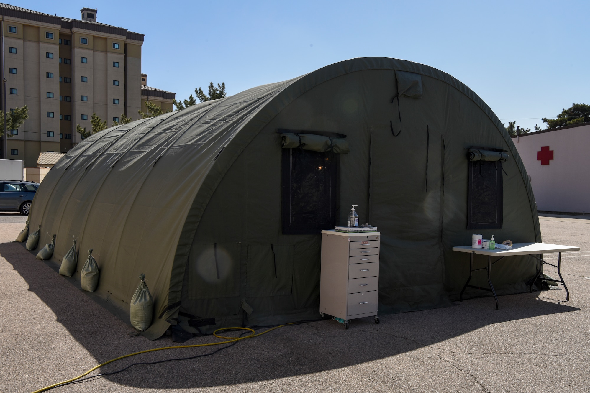 A tent sits in the 8th Medical Group parking lot at Kunsan Air Base, Republic of Korea, March 19, 2020. The 8th Medical Group took proactive and precautionary measures amid the COVID-19 pandemic by standing up a screening tent outside of the clinic for service members who have recently returned to Kunsan from international travel. (U.S. Air Force photo by Senior Airman Jessica Blair)
