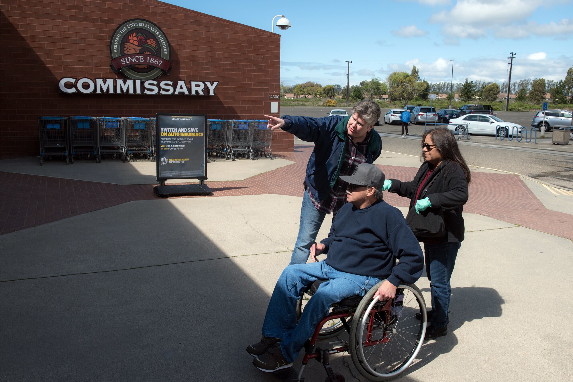 Photo of woman checking ID cards outside the commissary