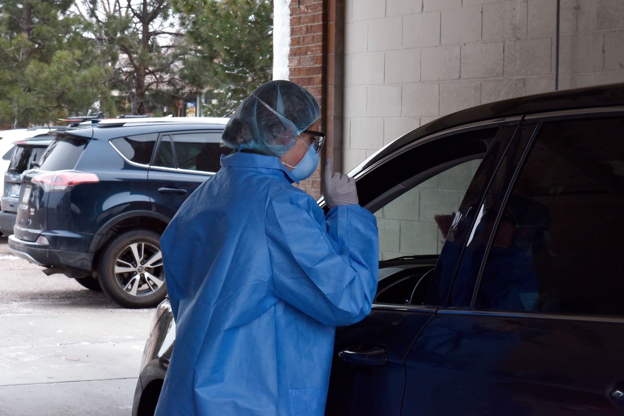 A 21st Medical Group professional tests an individual for the Coronavirus at Peterson Air Force Base, Colorado, March 20, 2020. In order to be tested for COVID-19, patients must first be evaluated by phone and meet criteria recommended by the Centers for Disease Control. Medical staff will test patients who will remain in their vehicle. (Air Force photo by Airman 1st Class Alexis Christian)