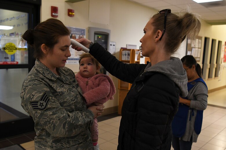 Providers at the 30th Force Support Squadron Child Development Center check the temperature of children and parents March 19, 2020, at Vandenberg Air Force Base, Calif.