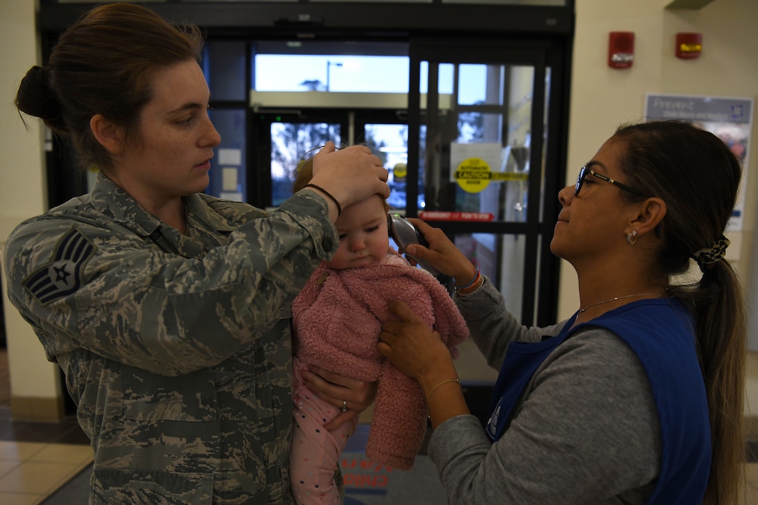 Providers at the 30th Force Support Squadron Child Development Center check the temperature of children and parents March 19, 2020, at Vandenberg Air Force Base, Calif.