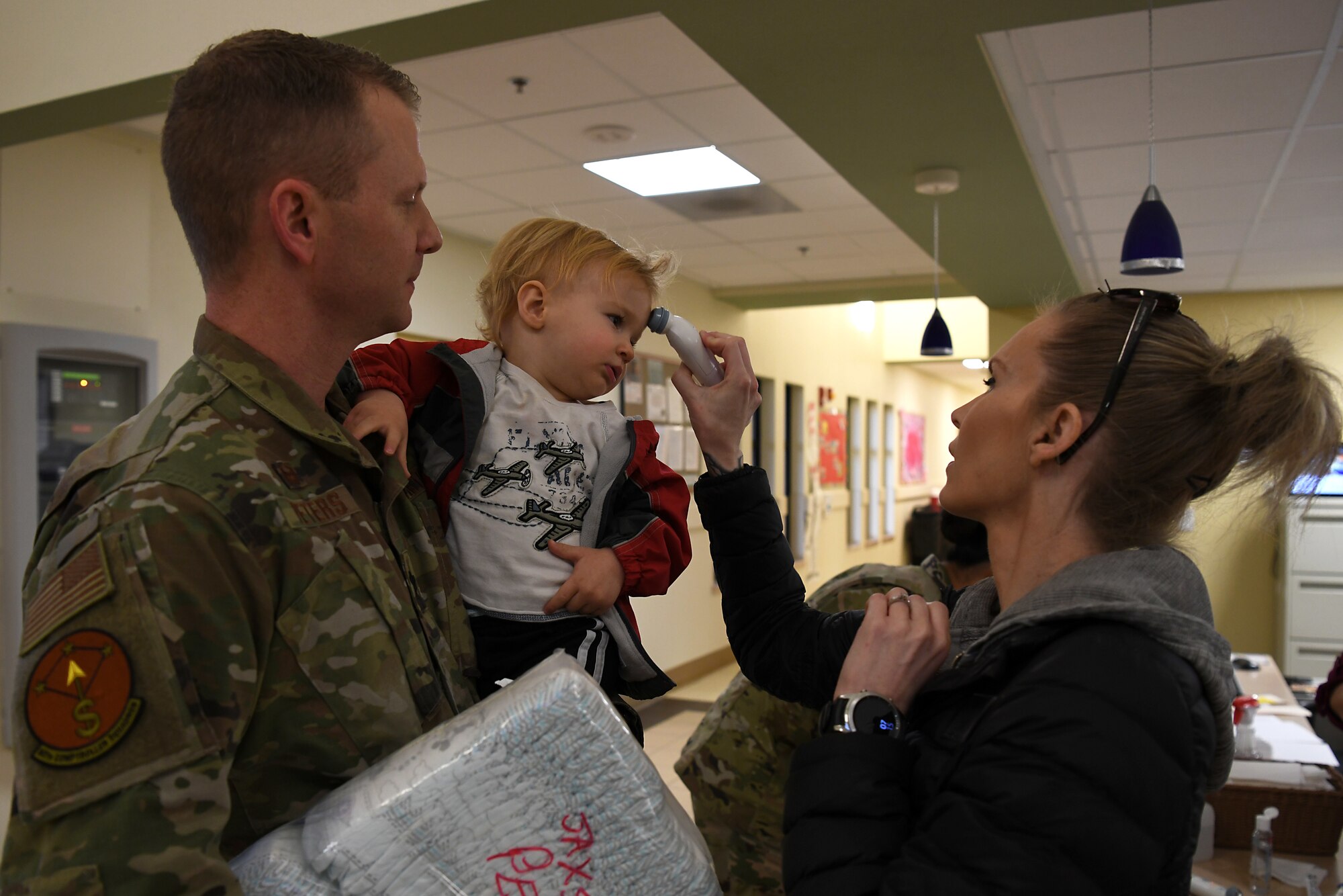 Providers at the 30th Force Support Squadron Child Development Center check the temperature of children and parents March 19, 2020, at Vandenberg Air Force Base, Calif.