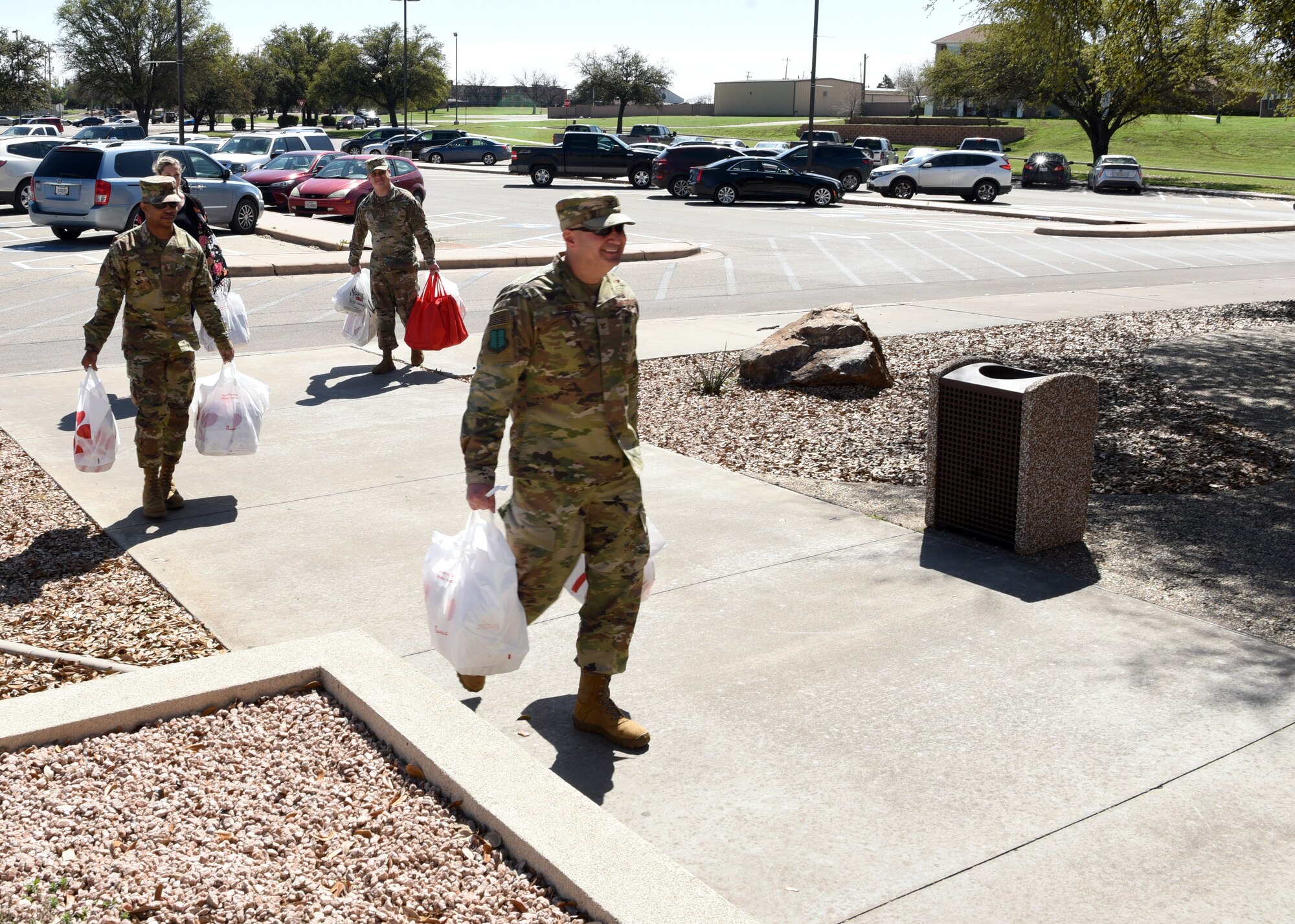 U.S. Air Force Col. Robert Ramirez, 17th Training Wing vice commander, and members of Goodfellow delivers lunch to the 17th Medical Group during a rush of patients at the Ross Clinic on Goodfellow Air Force Base, Texas, March 20, 2020.  The food was donated by the city of San Angelo community partners. (U.S. Air Force photo by Airman 1st Class Abbey Rieves)