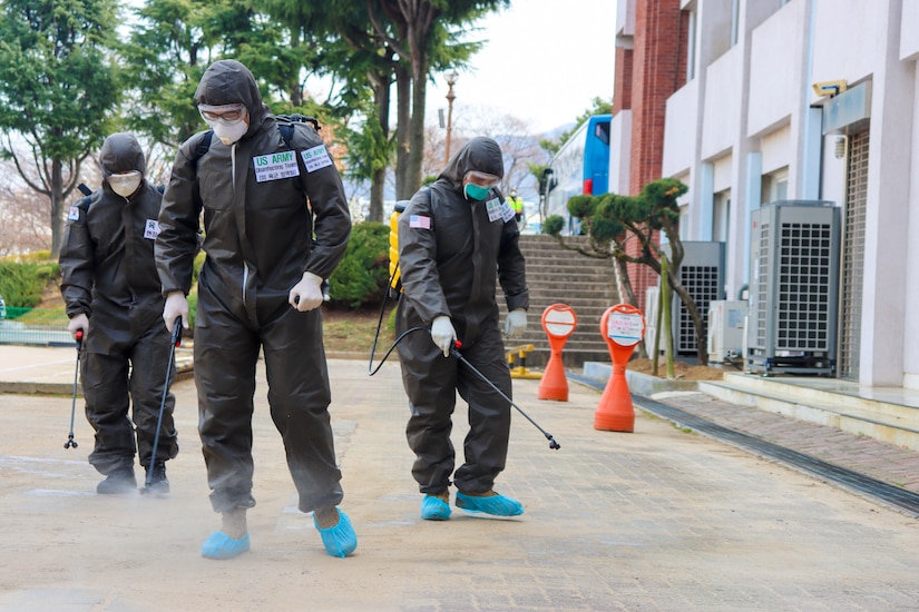 Soldiers spray disinfectant