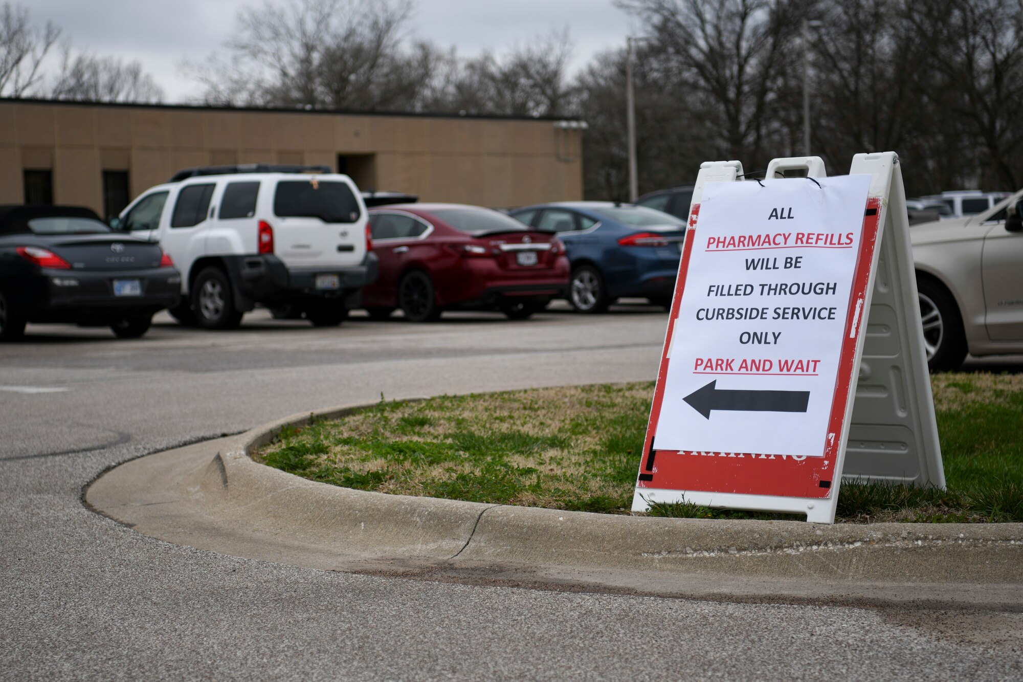 A sign located at the entrance of the 509th Medical Group, directs pharmacy patients to the new curb side pharmacy pickup at Whiteman Air Force Base, Missouri, March 20, 2020. The medical group’s pharmacy implemented curbside pickup pharmacy procedures. The new service allows individuals with called-in refills and activated prescriptions to park in a designated parking spots and have their prescriptions delivered to the car. This procedure is part of the effort to limit visiting the facility. (U.S. Air Force photo by Staff Sgt. Dylan Nuckolls)