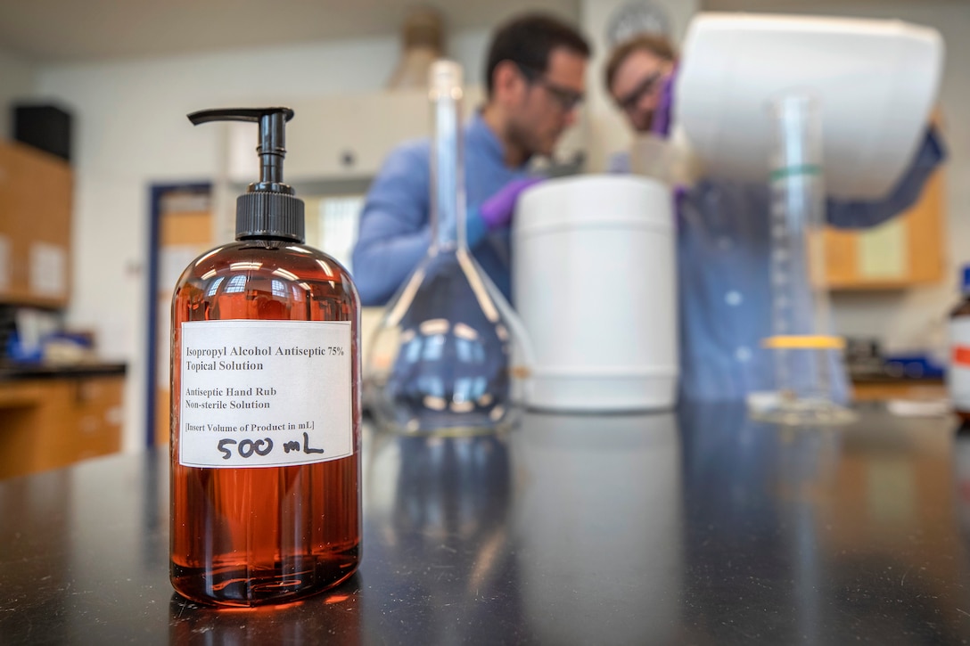 Code 134, Laboratory Division, chemists Anthony Painter and Deniz Ferrin made hand sanitizer March 20, 2020, inside the Puget Sound Naval Shipyard & Intermediate Maintenance Facility chem lab in Building 59, for use throughout the shipyard. (PSNS & IMF photo by Scott Hansen)
