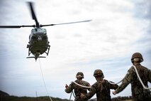 U.S. Service members from across Hawaii conduct special-patrol insertion and extraction rigging drills under the instruction of helicopter rope suspension techniques instructors with expeditionary operations training group, III Marine Expeditionary Force at Landing Zone Eagle, Marine Corps Base Hawaii, Mar. 19, 2020. SPIE rigging and rappelling techniques are used to rapidly insert and extract Marines when a landing zone is unavailable. (U.S. Marine Corps photo by Sgt. Alex Kouns)