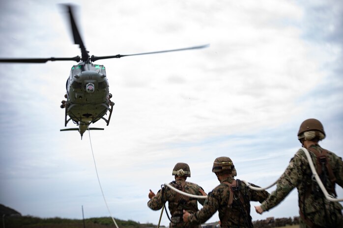 U.S. Service members from across Hawaii conduct special-patrol insertion and extraction rigging drills under the instruction of helicopter rope suspension techniques instructors with expeditionary operations training group, III Marine Expeditionary Force at Landing Zone Eagle, Marine Corps Base Hawaii, Mar. 19, 2020. SPIE rigging and rappelling techniques are used to rapidly insert and extract Marines when a landing zone is unavailable. (U.S. Marine Corps photo by Sgt. Alex Kouns)