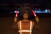 A member of Team Charleston marshals a C-130 Hercules at Joint Base Charleston, S.C., March 20, 2020.
