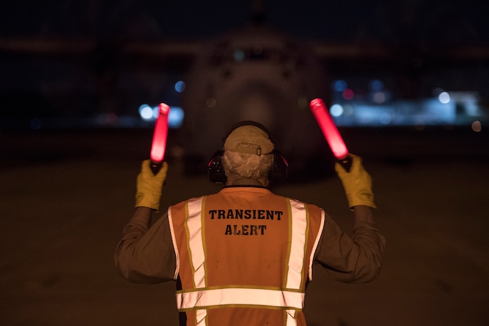 A member of Team Charleston marshals a C-130 Hercules at Joint Base Charleston, S.C., March 20, 2020.