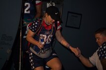 A member of the U.S. women’s football team gets off a C-130 Hercules at Joint Base Charleston, S.C., March 20, 2020.