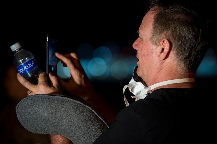 A passenger takes a picture of a C-130 Hercules at Joint Base Charleston, S.C., March 20, 2020.