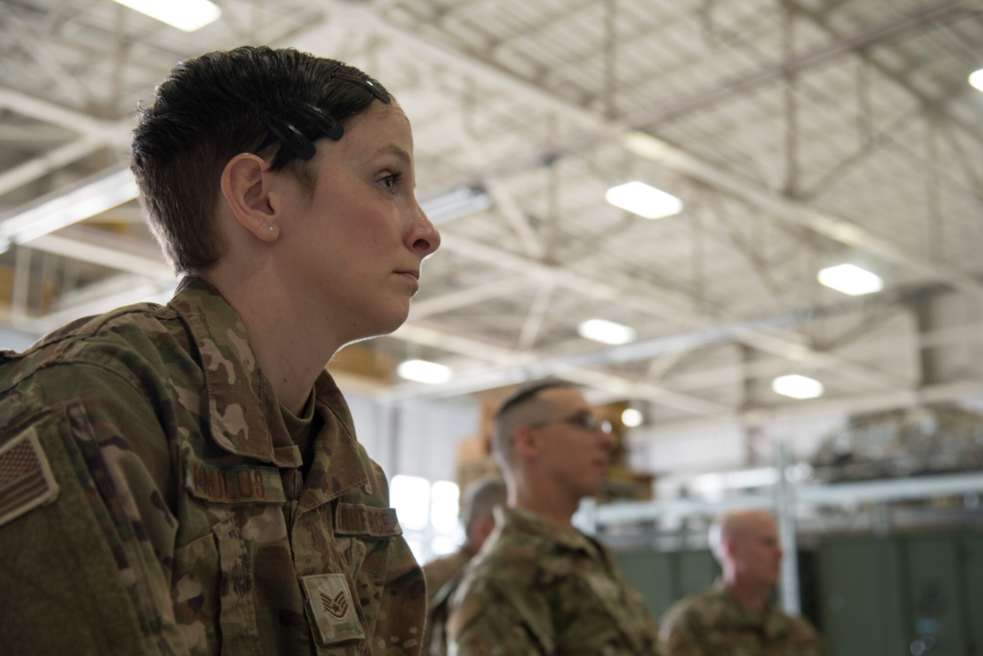 Photo of a servicemember listening to a brief.