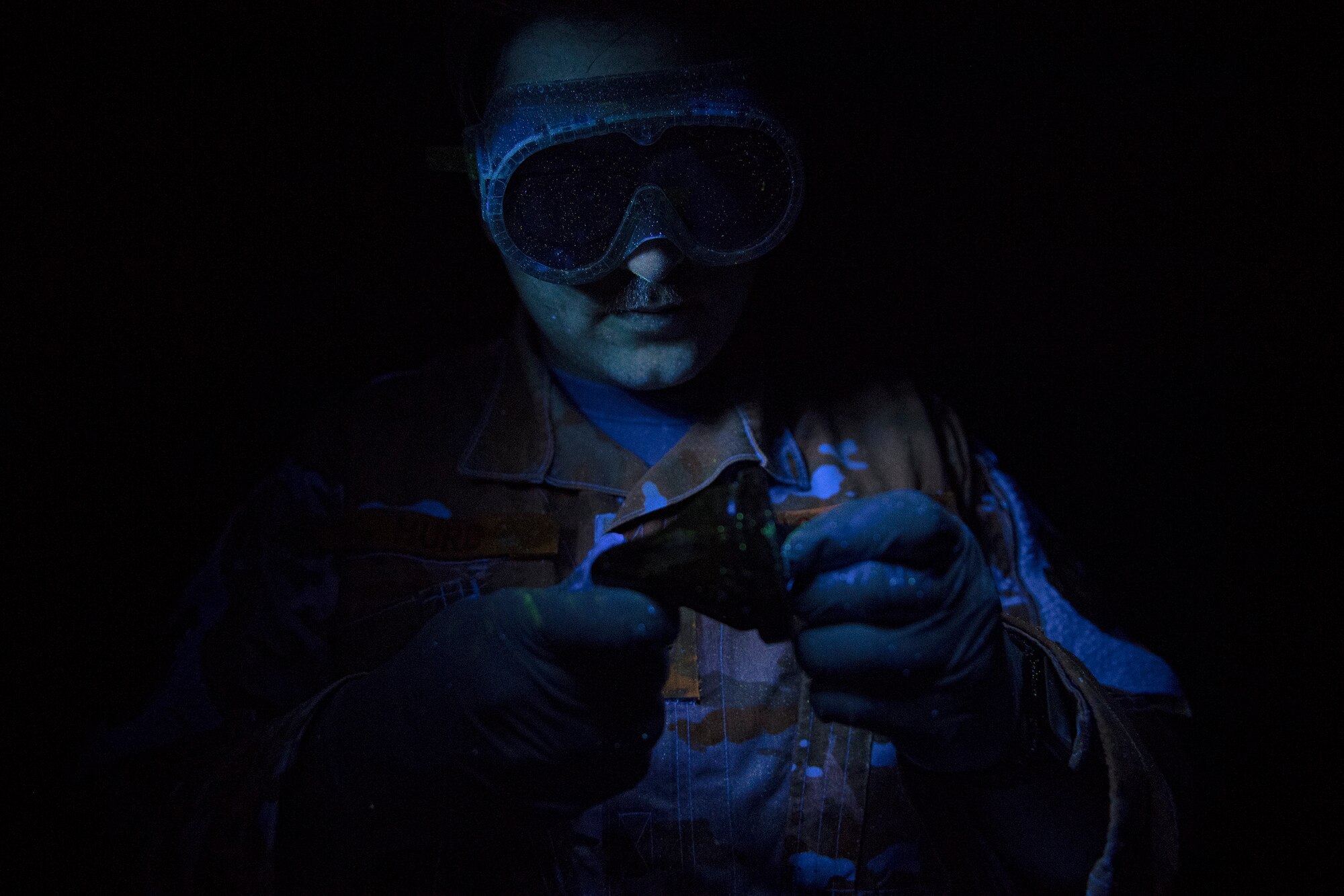 Senior Airman Christopher Hurd, 51st Maintenance Squadron nondestructive inspection technician, examines defects during an inspection at Osan Air Base, South Korea, March 16, 2020. NDI technicians use dyes and other methods to search for cracks and other imperfections in aircraft and aircraft parts. (U.S. Air Force photo by Staff Sgt. Greg Nash)