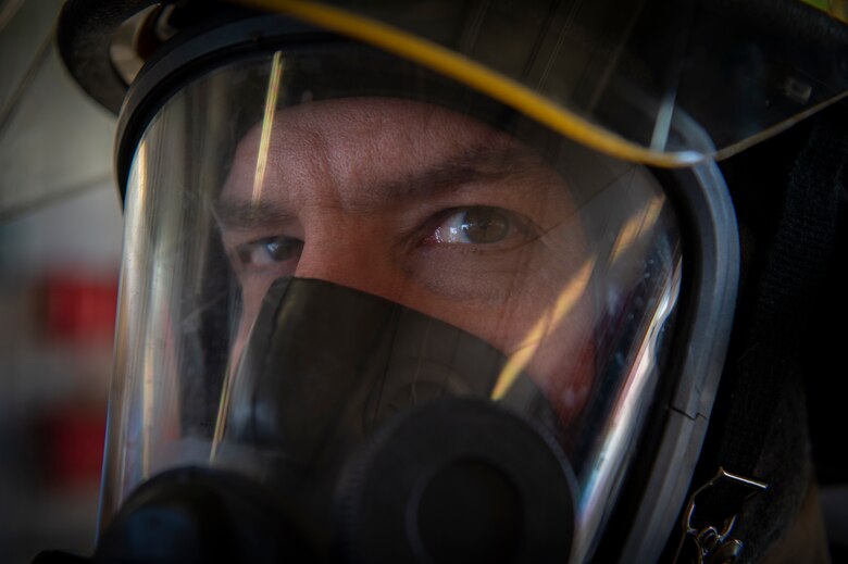 Jim Kuhn, 50th Civil Engineer Squadron firefighter, wears protective gear during an equipment inspection at Schriever Air Force Base, Colo., March 6, 2020. Firefighters wear respiratory equipment when responding in hazardous environments that could hinder their ability to breathe, such as an area with heavy smoke. (U.S. Air Force photo by Airman 1st Class Jonathan Whitely)