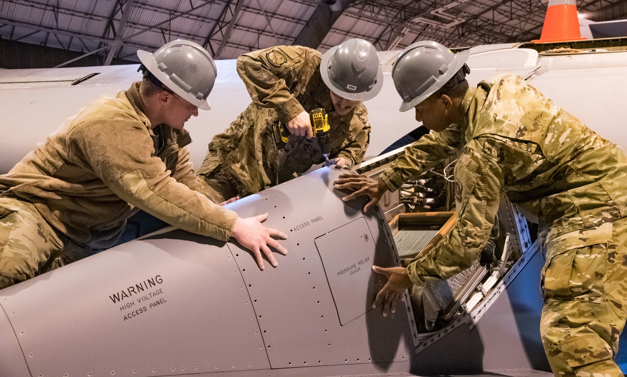 Senior Airman Brian Dawson and Airman 1st Class Quantavius Martin, 436th Maintenance Squadron aircraft maintenance journeymen, hold down a pylon panel as Senior Airman Mike Carlucci installs fasteners in the C-5M Galaxy Isochronal Inspection Dock at Dover Air Force Base, Del., March 17, 2020. The C-5M Galaxy Isochronal Inspection Dock keeps inventory of the largest aircraft in the Air Force. (U.S. Air Force photo by Roland Balik)