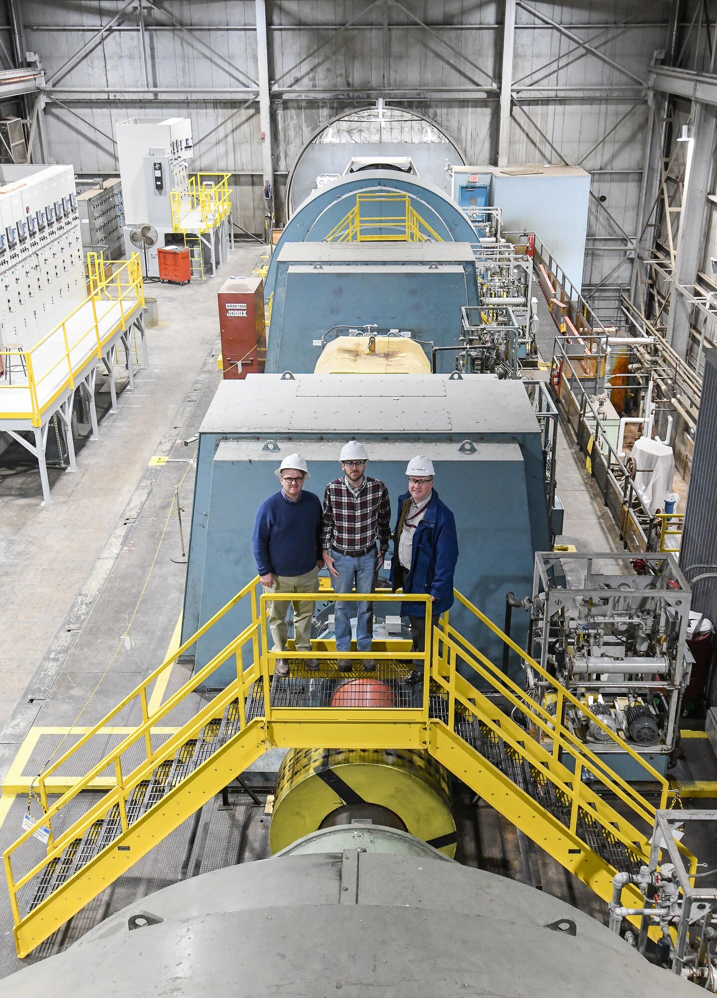 Shelby Moorman, left, an electrical systems engineer, Ethan Jobe, a plant operations engineer, and Tyler McCamey, a program manager, pose for a photo in the Main Drive building of the Arnold Engineering Development Complex (AEDC) Propulsion Wind Tunnel (PWT) Facility Feb. 7, 2020, at Arnold Air Force Base, Tenn. AEDC team members determined a new configuration of the motors to power the compressors, resulting in a significant power savings. (U.S. Air Force photo by Jill Pickett)