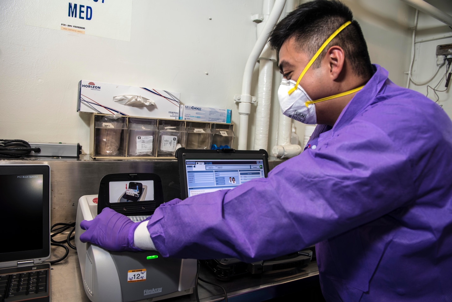 SOUTH CHINA SEA – (March 14, 2020) Hospital Corpsman Gian Molina, assigned to Navy Environmental Preventative Medicine Unit Six, tests samples in a BioFire Film Array, which will test for nearly 30 different diseases, aboard the U.S. 7th Fleet flagship USS Blue Ridge (LCC 19). To date, no cases of COVID-19 have been detected aboard any 7th Fleet U.S. Navy vessels, but if a case were to arise, ships have isolation plans in place to contain the infection. As the U.S. Navy's largest forward-deployed fleet, 7th Fleet operates roughly 50-70 ships and submarines and 140 aircraft with approximately 20,000 Sailors.