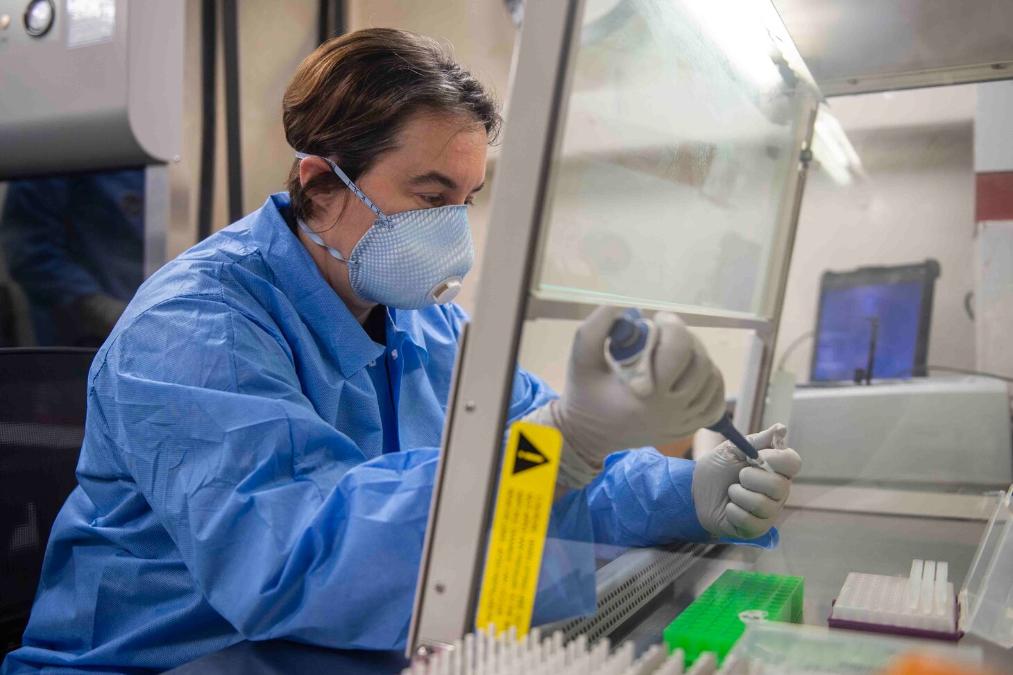 PHILIPPINE SEA (March 18, 2020) Lt. Cmdr. Danett Bishop, from Hawthorn Woods, Illinois, tests respiratory samples in the biological safety lab of amphibious assault ship USS America (LHA 6). America, flagship of the America Expeditionary Strike Group, 31st Marine Expeditionary Unit team, is operating in U.S. 7th Fleet area of operations to enhance interoperability with allies and partners and serve as a ready response force to defend peace and stability in the Indo-Pacific region.