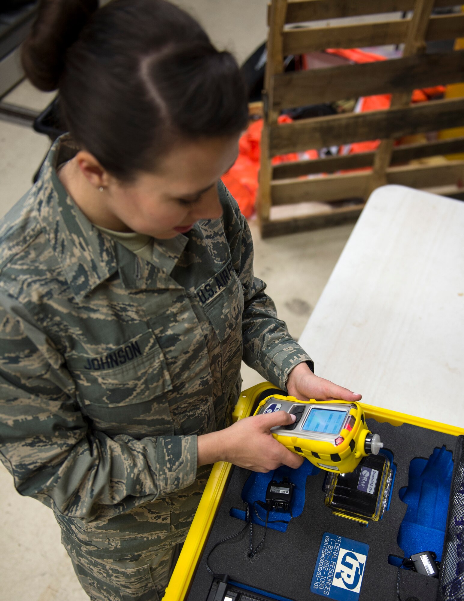 U.S. Air Force Senior Airman Morgan Johnson, an emergency manager with the 133rd Civil Engineer Squadron, turns the of a Multirae Gas Monitor one in St. Paul, Minn., March 11, 2020.