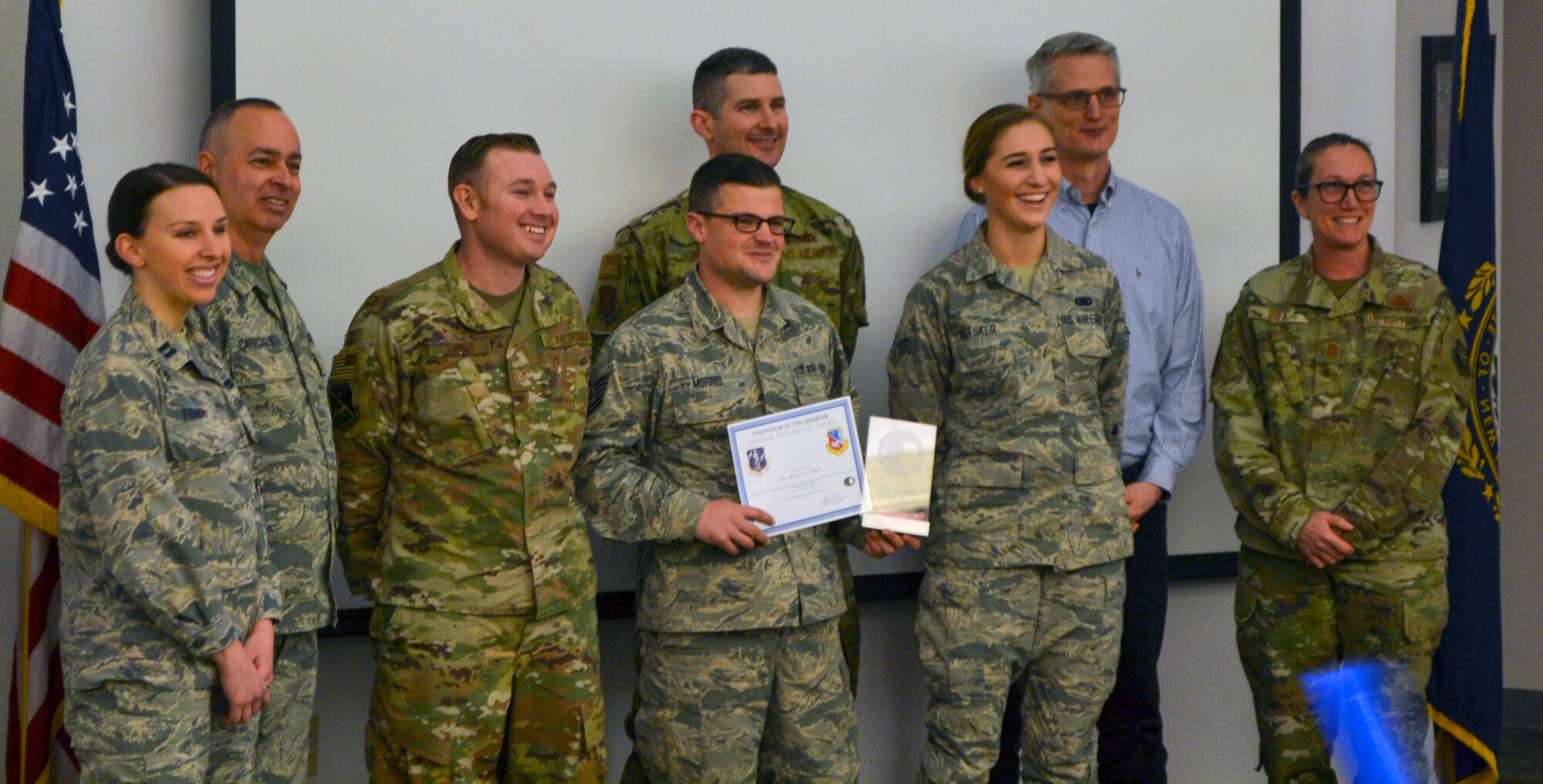 Airmen and guest judges celebrate the selection of Staff Sgt. Michael Morris as the winner of the 157th Air Refueling Wing's inaugural Spark Tank Alpha event, March 8, 2020, at Pease Air National Guard Base, N.H. The event promotes innovative ideas and concepts on improving the Air Force. From left, Capt. Emily Fisher, maintenance system software portfolio owner assigned to Kessel Run in Boston; Senior Master Sgt. Michael Caracoglia, Wildcat Spark Hub superintendent; Tech. Sgt. Jason Cuhna, contestant assigned to 157 Maintenance Group; Staff Sgt Michael Morris, winner and crew chief assigned to 157th Maintenance Group; Col. Todd Swass, 157th Air Refueling Wing vice commander; Senior Airman Emma Nofsker, contestant assigned to the 157th Logistics Readiness Squadron; Mr. Robert Miles, University of New Hampshire, senior lecturer decision sciences; and Chief Master Sgt. Erica Rhea, 157th Air Refueling Wing command chief; (Courtesy photo by Desirae Caracoglia)
