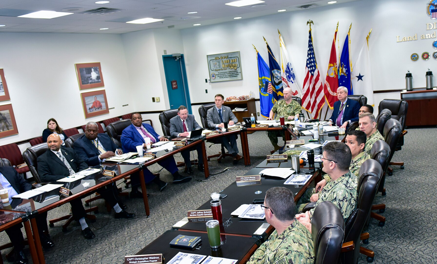 DLA Land and Maritime leadership sitting at a table.