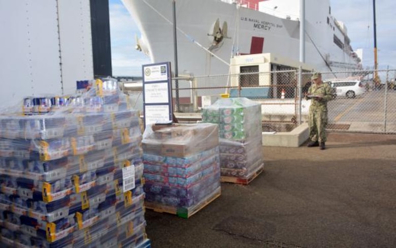 Pallets of supplies await to be craned aboard Military Sealift Command hospital ship USNS Mercy (T-AH 19) at Naval Base San Diego, March 21. Huntsville Center is providing an $187,000 information technology software acquisition for the Mercy as the ship serves as a referral hospital for non-COVID-19 patients currently admitted to shore-based hospitals.