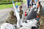 Soldiers with the Louisiana Army National Guard’s 256th Infantry Brigade Combat Team don protective suits as they prepare to administer nasal swabs to first responders and medical personnel at a mobile testing site in Westwego, Louisiana, March 21, 2020. More than 8,000 National Guard members in all 54 states, territories and the District of Columbia have been called out in to support state and local officials responsing to COVID-19.