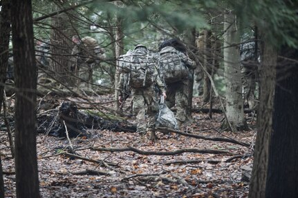 Soldiers assigned to Charlie Troop, 2nd Battalion, 101st Cavalry regiment of the New York Army National Guard from Buffalo enter the woods at Beaver Hollow, N.Y., during tday and nighttime reconnaissance training, March 13, 2020.