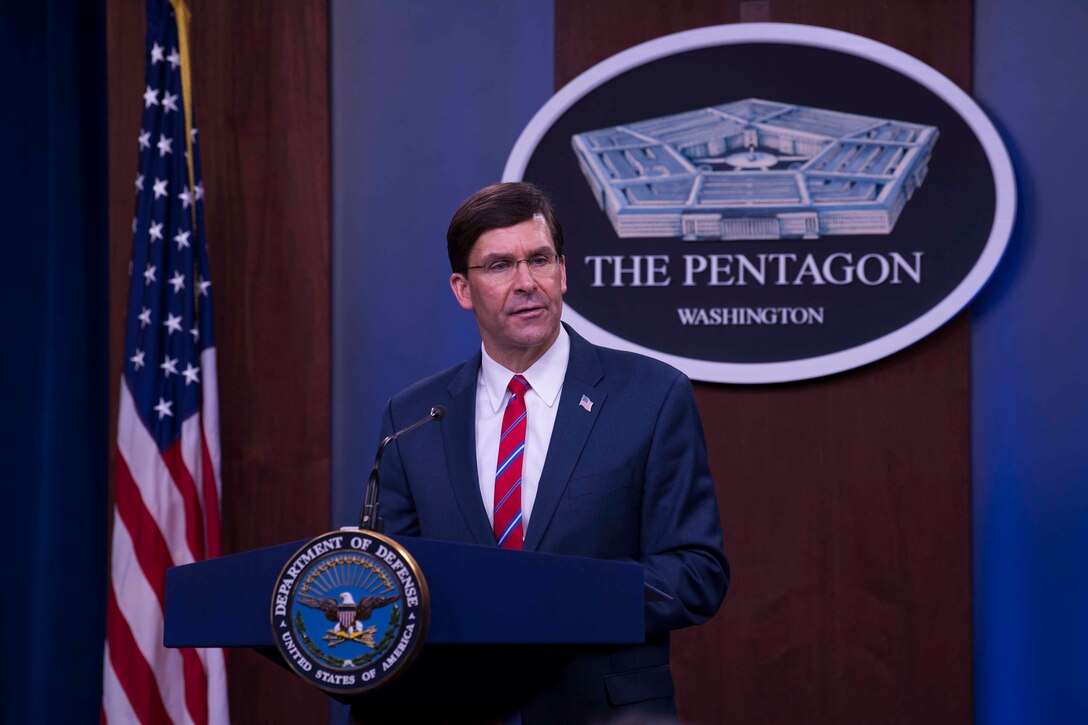 Defense Secretary Dr. Mark T. Esper stands behind a podium.